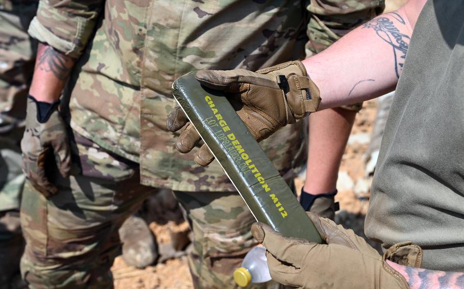 A U.S. soldier holds an block of C4.