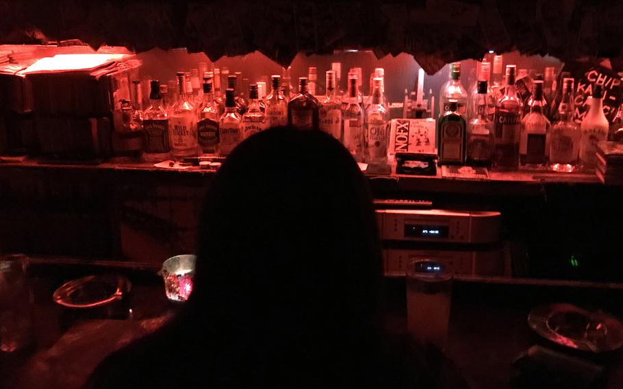 Bottles of alcohol are lined up behind a bar in Japan.