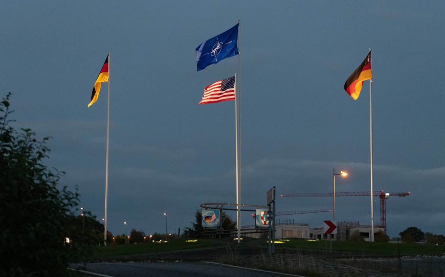 Flags on flagpoles outside the main gate to a U.S. Air Force base.