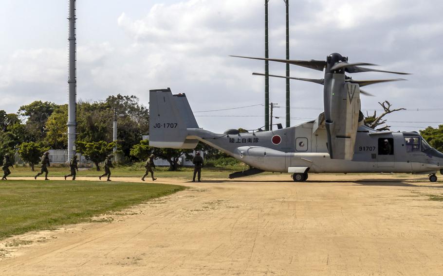 Japanese soldiers board a V-22 Osprey while training with U.S. forces in Tokunoshima, Japan, March 2, 2023.