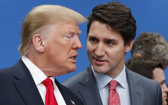 Donald Trump and Justin Trudeau stand next to each other and speak.