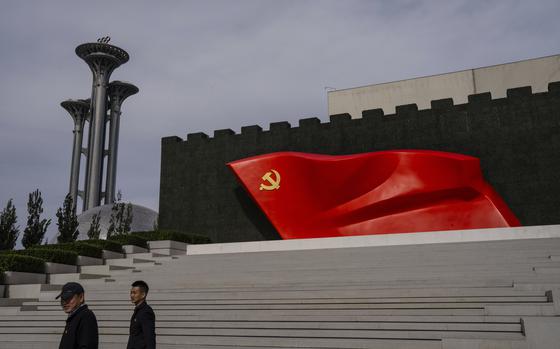 FILE - Visitors pass the Chinese Communist Party flag at the museum of the Communist Party of China in Beijing, Oct. 19, 2023. (AP Photo/Louise Delmotte, File)