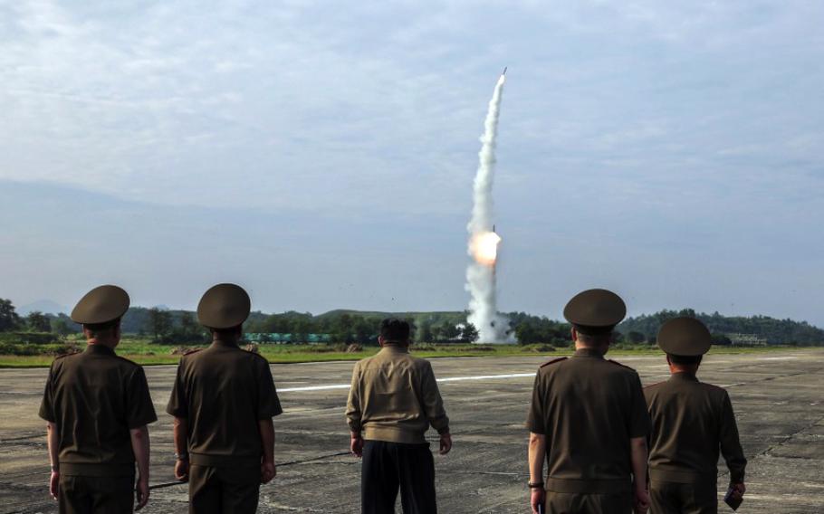 North Korean leader Kim Jong Un, center, watches a missile launch alongside military officials in this image released by the state-run Korean Central News Agency on Sept. 19, 2024.