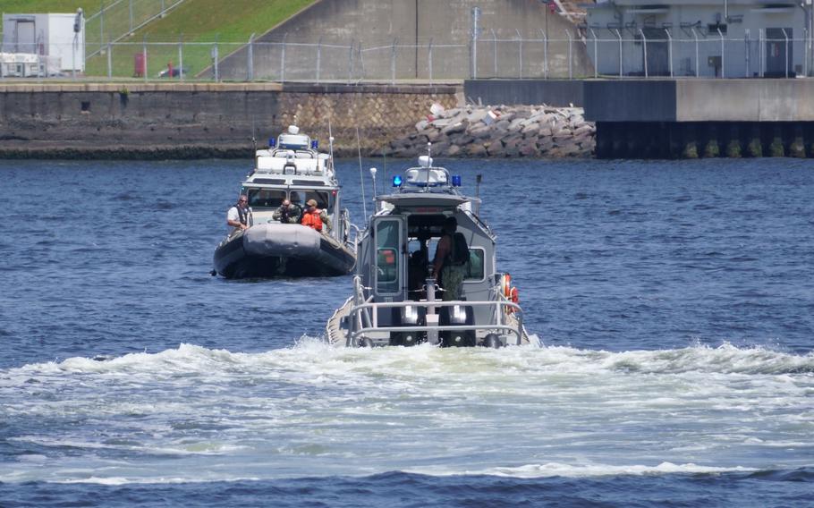 U.S. Navy security teams prepare to fire blank rounds during a harbor security exercise near Yokosuka Naval Base, Japan, June 5, 2024.