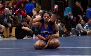 Ramstein's Genesis Esparza flips Kaiserslautern's Uno Tate on her back during a 115-pound girls wrestling match on Dec. 7, 2024, at Ramstein High School on Ramstein Air Base, Germany.