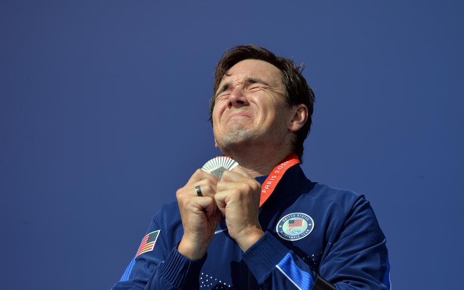 Dennis Connors of the United States clutches his silver medal he won in the men's T1-2 para cycle road race at the  2024 Paris Paralympics Sept. 7, 2024 in Clichy-sous-Bois, France.