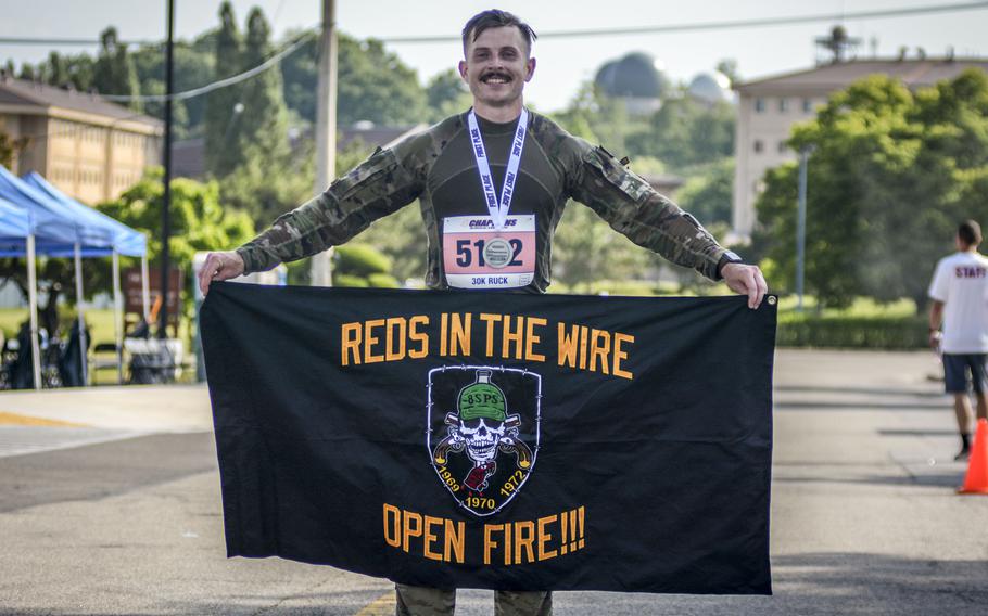 Tech. Sgt. Jeffery Herron of the 8th Security Forces Squadron at Kunsan Air Base celebrates his first-place finish in a Norwegian foot march at Osan Air Base, South Korea, on May 18, 2024. 