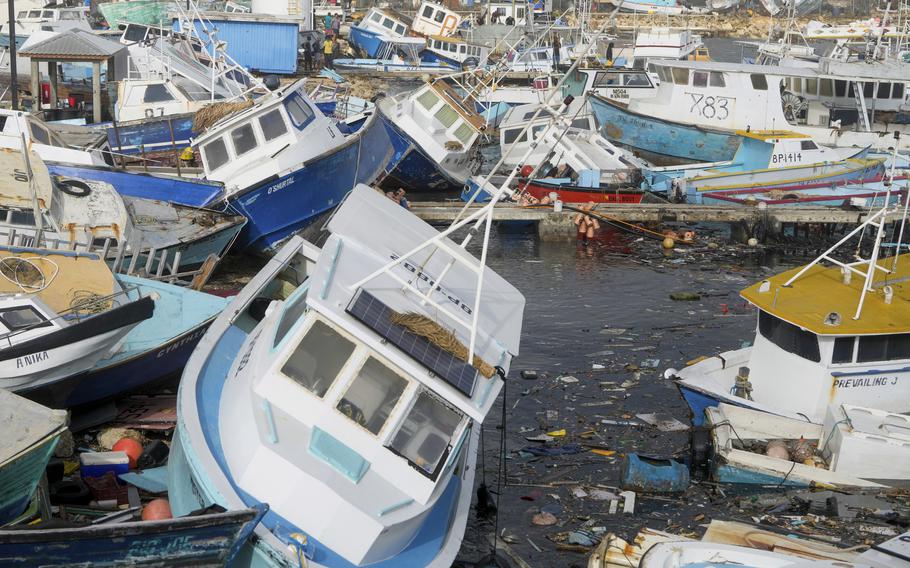 Fishing vessels damaged by Hurricane Beryl sit upended at the Bridgetown Fisheries in Barbados on July 1, 2024.