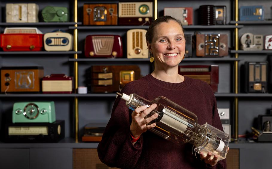 Against a wall of the Bay Area Radio Museum’s massive collection, Rachel Lee, executive director of the California Historical Radio Society, stands with a large transmission vacuum tube, on March 6 in Alameda, Calif. The museum is run by volunteers from the society.