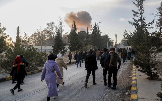 A Turkish drone strike hits near protesters demanding an end to the war around the Tishrin Dam, Syria, Wednesday, Jan. 8, 2025. Turkish drones and warplanes hovered during the protest, with airstrikes targeting areas near the march route, according to participants and a war monitor. The health administration in Kobani reported five civilians killed and 15 injured. (AP Photo/Baderkhan Ahmad)