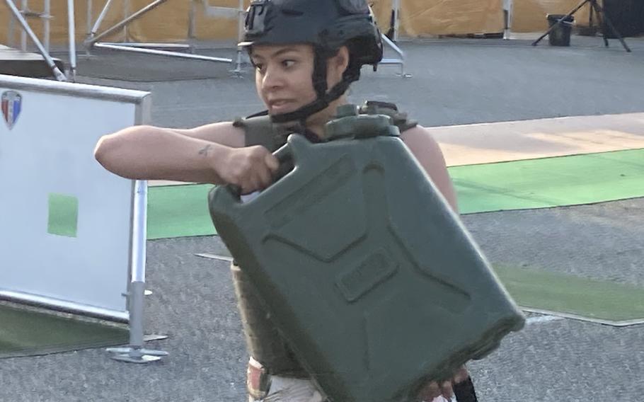 Sgt. Patricia Martinez hefts one of five full, 40-plus pound jerrycans as part of Fort Eustis' battle challenge competition on May 24, 2021.