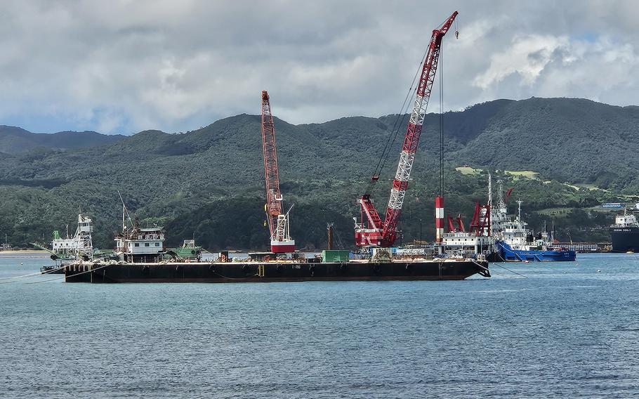 A crane floats on a bay.