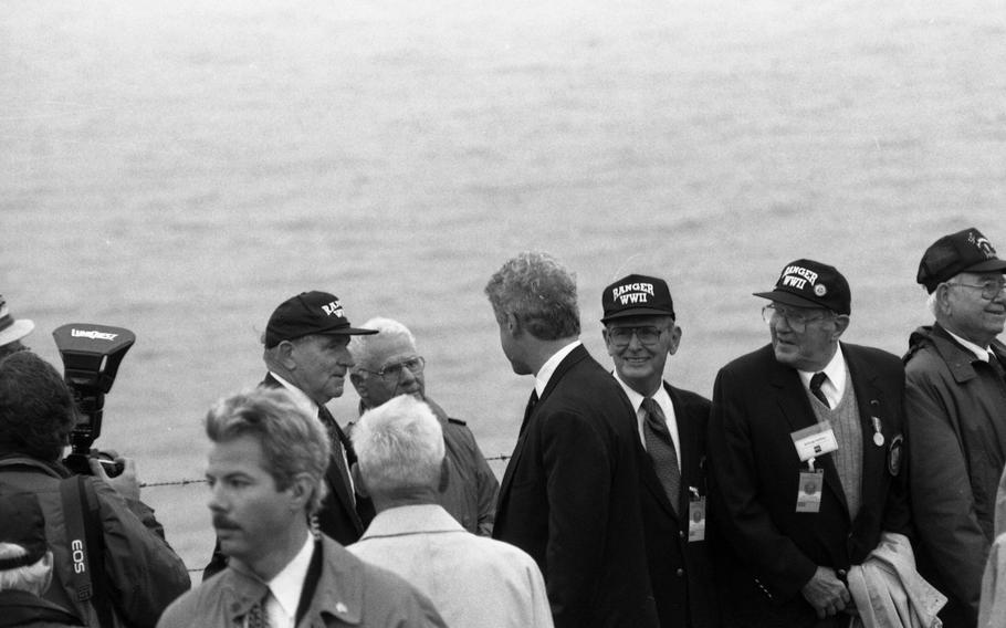 President Bill Clinton talks to D-Day U.S. Rangers veterans at the ceremony commemorating the D-Day landing at Pointe du Hoc, France, near Omaha Beach. The gathered crowd included many U.S. Ranger veterans who scaled the 100-foot cliffs to knock-out the German artillery overlooking the landing beaches. Some 70 percent of the Rangers that landed at Point du Hoc that day was killed, wounded or reported missing.