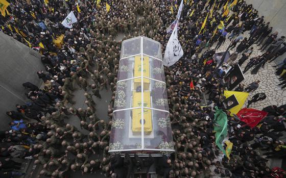 Huge crowds gather as coffins are transported.