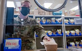 A pharmacy technician with the 18th Medical Support Squadron hands a prescription to a patient at Kadena Air Base, Okinawa, Nov. 16, 2021. 