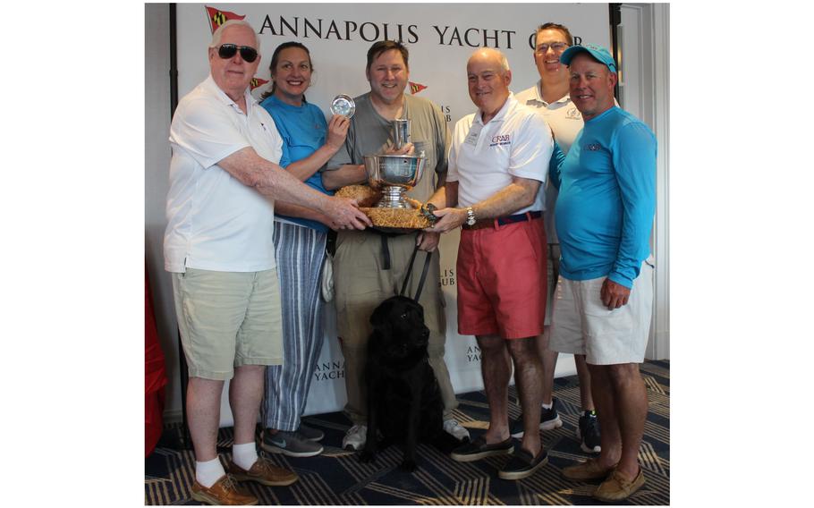 Jay Streit, third from left, poses with the Don Backe Memorial Regatta trophy June 10, 2023, at the Annapolis Yacht Club in Maryland. The Navy veteran won the event for the second consecutive year.