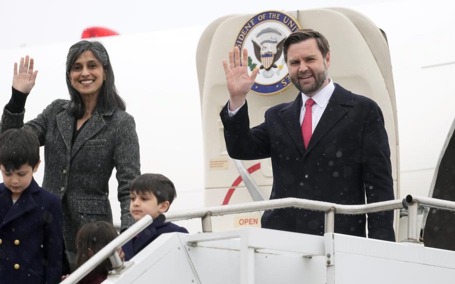 The Vance family waves while walking off the plane.