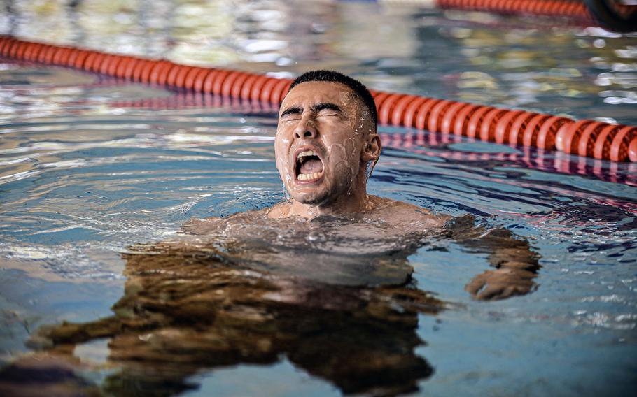 U.S. Space Force Tech. Sgt. Mark Fitzgerald, with the 53rd Satellite Operations Squadron in Landstuhl, Germany, removes his uniform top while treading water 