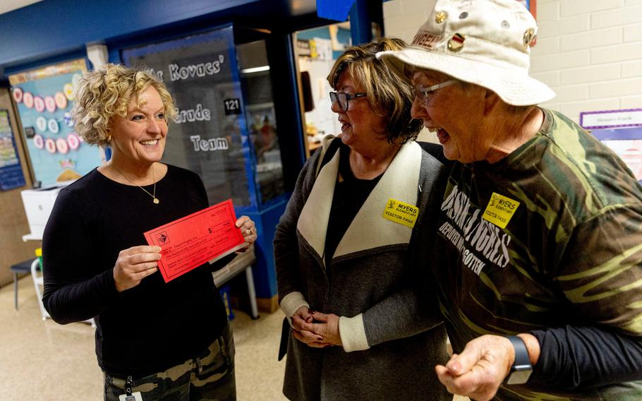 Second grade teacher Heidi Hawley, left, presents a check to Desert Angel founder Louise Blaine