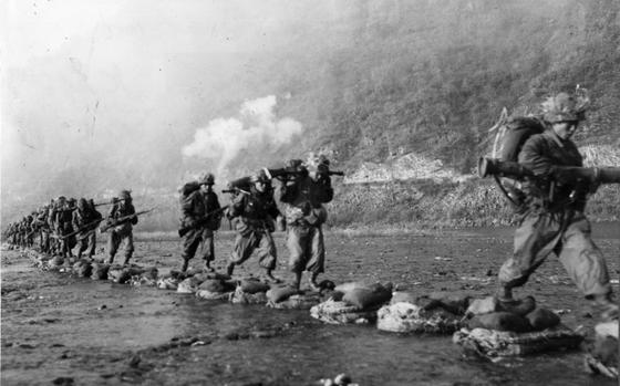 ROK troops cross a river during Operation Killing Zone.  