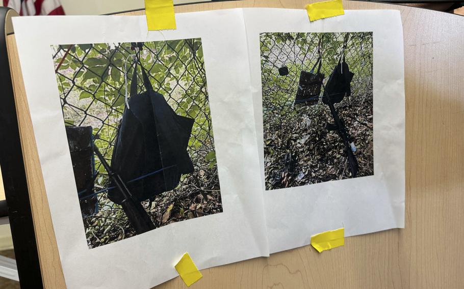 Photos displayed during a news conference show an AK-47 rifle, a backpack and a Go-Pro camera on a fence outside Trump International Golf Club