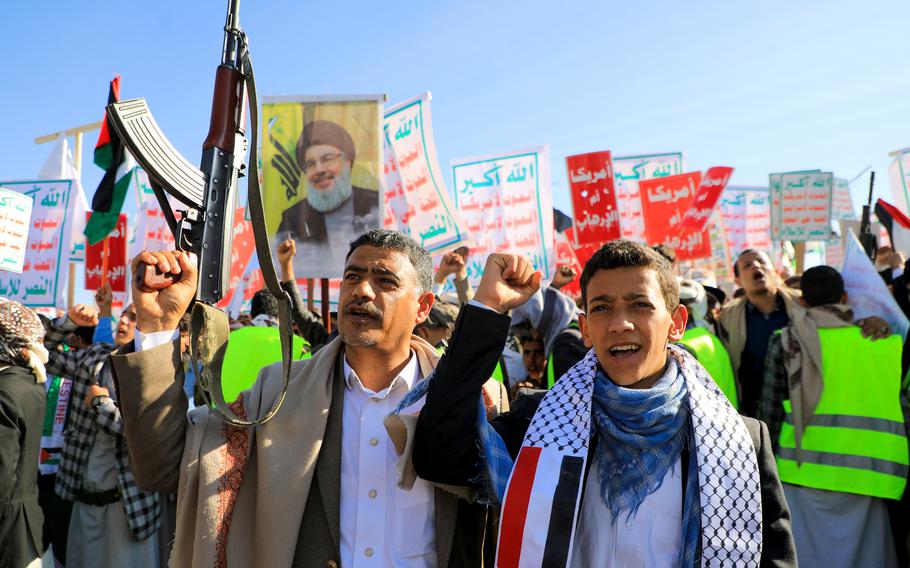 Protesters lift placards and a portrait of Lebanon’s Hezbollah leader Hassan during an anti-Israel and anti-U.S. rally in the Houthi-controlled Yemeni capital Sanaa on Jan. 26, 2024, amid ongoing battles between Israel and the Palestinian Hamas group in Gaza.