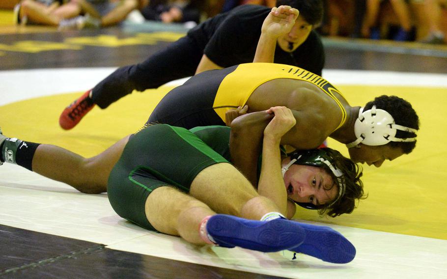 Kadena 160-pounder James Kinney gets the advantage on Kubasaki’s Max Lundberg during Wednesday’s Okinawa wrestling dual meet. Kinney pinned Lundberg in 1 minute, 46 seconds and the Panthers won the meet 40-23, improving to 3-0 over the Dragons this season.
