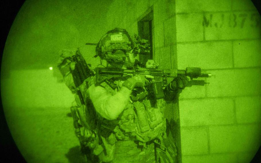 A Naval Special Warfare operator provides security as part of a nighttime direct-action raid training in California in May 2024. The Pentagon is not doing enough to ease the transition of Special Operations Forces service members who choose to leave the military, according to a Government Accountability Office report. 