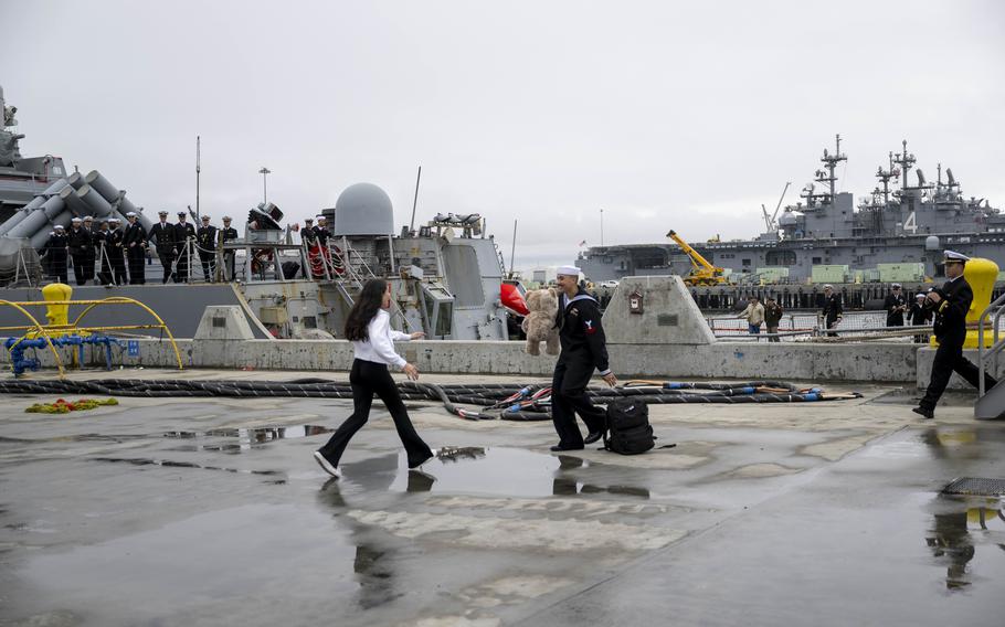 A sailor embraces a loved one