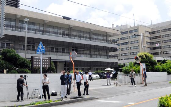 Reporters covering a U.S. airman’s sexual assault and kidnapping charges wait outside Naha District Court on Okinawa, Friday, Aug. 30, 2024.