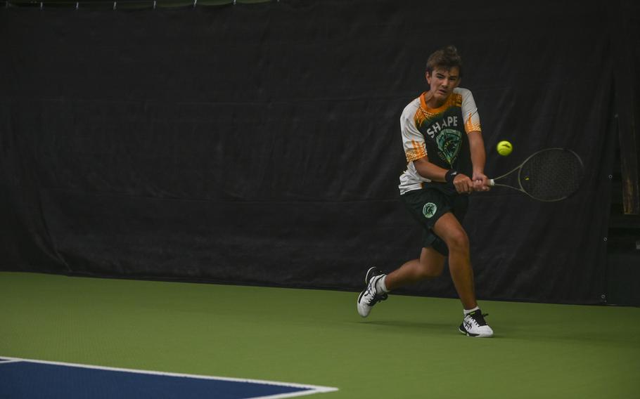 SHAPE’s Alejandro Cuesta reaches a swiftly moving ball with a backhand during his intense match for third place boys singles against Sam Grady at the DODEA European tennis championships at T2 Sports Health Club in Wiesbaden, Germany, on Oct. 21, 2023.