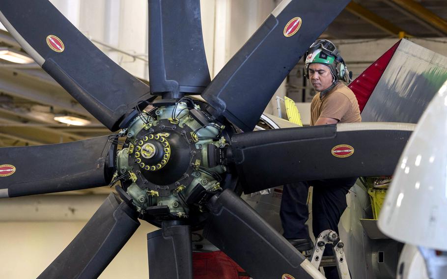 Maintenance on the propeller of an E-2D Advanced Hawkeye