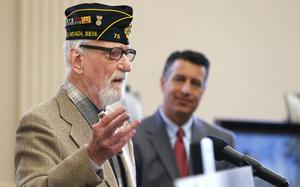 Gov. Brian Sandoval, rear, listens as Pearl Harbor survivor Charles Sehe speaks at the USS Nevada Centennial Ceremony at the Capitol in Carson City on Friday, March 11, 2016. Sehe was serving on the USS Nevada when it was attacked at Pearl Harbor. (Las Vegas Review-Journal/File)