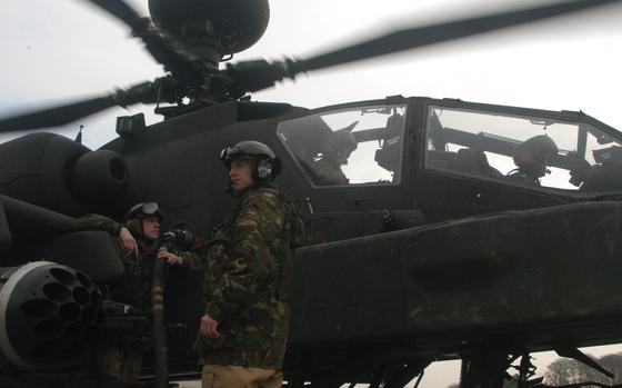 Salisbury Training Ground, England. Jan. 30, 2009: British maintainers gas up a British Apache helicopter at Salisbury Training Ground, near Stonehenge.

Read the 2009 story of US/UK cooperation here.
https://www.stripes.com/migration/apaches-in-arms-american-helo-pilot-serves-with-u-k-counterparts-1.90419

META TAGS: Military Personnel Exchange Program; U.S. Army; British army; international cooperation;