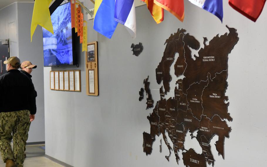 A map on the wall, with flags above.