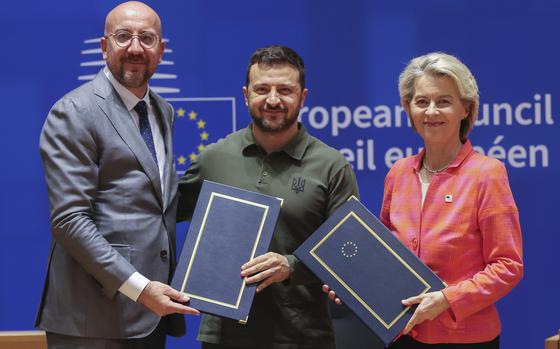 European Council President Charles Michel, left, and European Commission President Ursula von der Leyen, right, pose with Ukraine's President Volodymyr Zelenskyy as they take part in a signature ceremony of a security agreement during an EU summit in Brussels, Thursday, June 27, 2024. European Union leaders are expected on Thursday to discuss the next EU top jobs, as well as the situation in the Middle East and Ukraine, security and defence and EU competitiveness. 