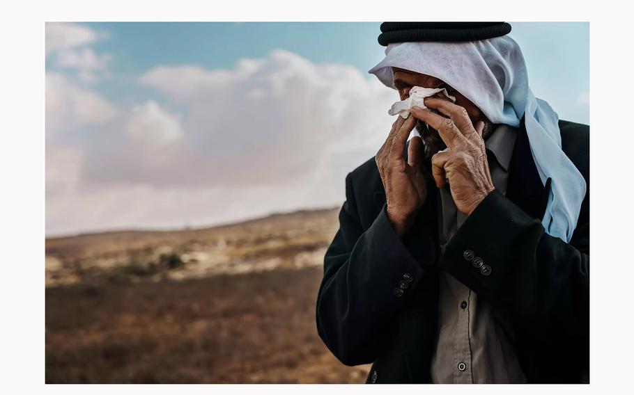 Jibreen Abu Aram weeps as he talks about Jewish settlers who he says have beaten him, poisoned his sheep and threatened to kill his family in Qawawis in the occupied West Bank.