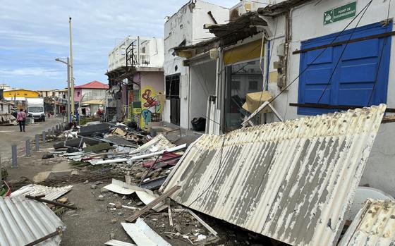 Debris are seen in a street of Mamoudzou, in the French Indian Ocean territory of Mayotte, Monday, Dec.16, 2024 and France uses ships and military aircraft to rush rescue workers and supplies after the island group was battered by its worst cyclone in nearly a century. (AP Photo/Rainat Aliloiffa)