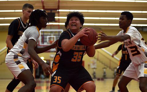 Spangdahlem's Jesus Nunez goes up under the basket against Baumholder's Gregory Makubuya, left and Semaj Stukes during a Dec. 13, 2024, game at the Hall of Champions in Baumholder, Germany.