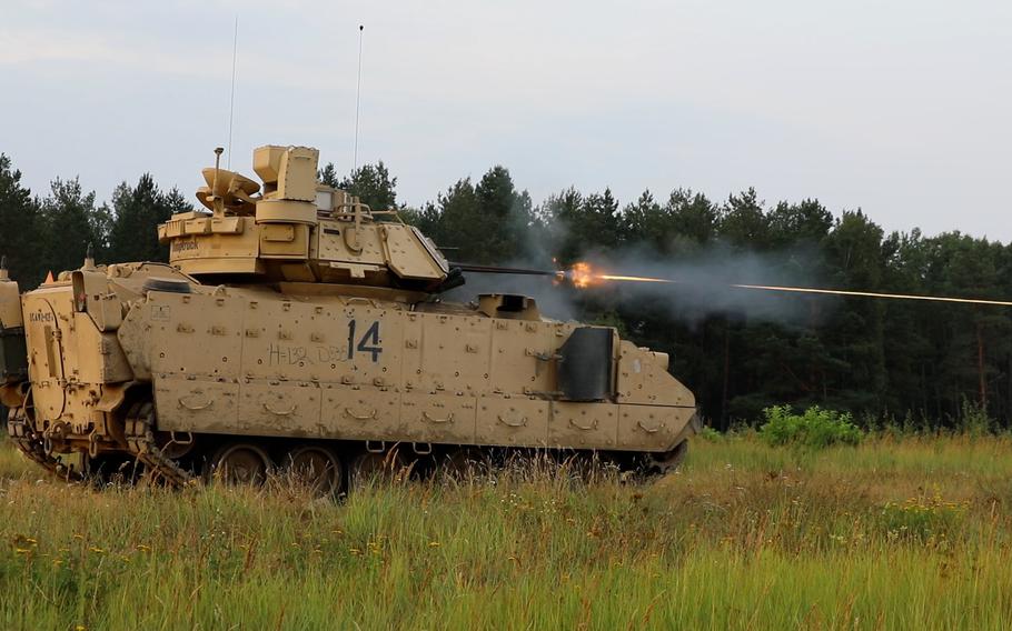 U.S. soldiers with the 3rd Armored Brigade Combat Team of the 1st Cavalry Division fire the cannon on a Bradley Fighting Vehicle in Poland in August 2022.