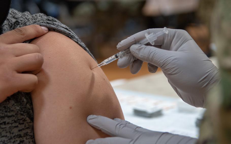 A coronavirus vaccine is administered at Naval Base San Diego.