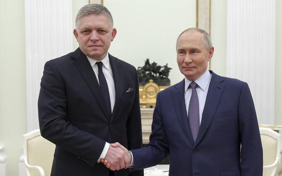 Russian President Vladimir Putin, right, and Slovak Prime Minister Robert Fico shake hands during their meeting at the Kremlin in Moscow, Russia, Sunday, Dec. 22, 2024. (Gavriil Grigorov, Sputnik, Kremlin Pool Photo via AP)