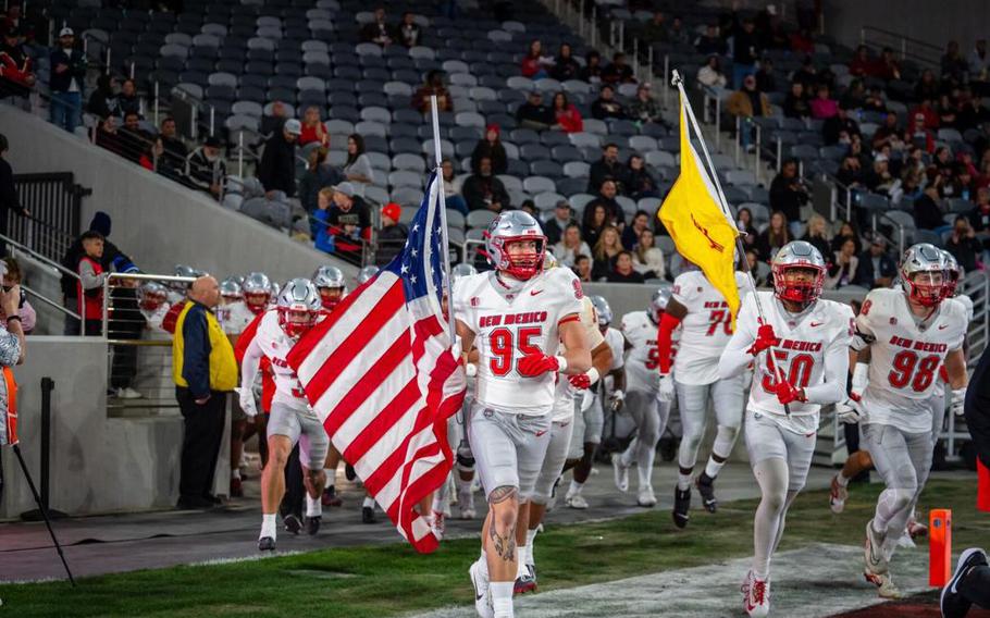 New Mexico edge rusher Colby Brewer runs out onto the field prior to a 21-16 win over San Diego State at Snapdragon Stadium on Nov. 8, 2024.