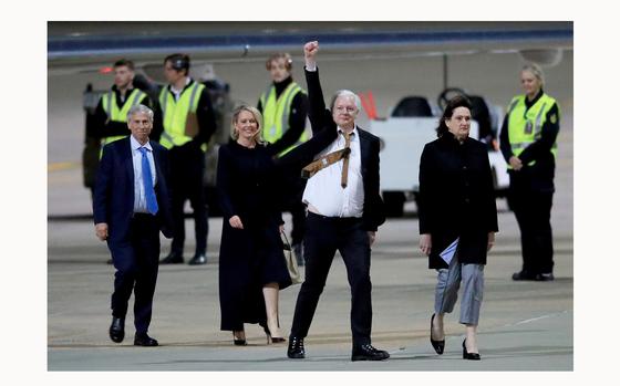 WikiLeaks founder Julian Assange (C) gestures as he arrives at Canberra Airport on June 26, 2024 in Canberra, Australia. Julian Assange, the WikiLeaks founder, returned to his native Australia as a free man, after attending the U.S. District Court for the Northern Mariana Islands in Saipan on Wednesday. Following his guilty plea to a felony charge under the Espionage Act, Assange was sentenced to time served and subsequently released, allowing him to walk free after years of incarceration and intense lobbying for his release from across the political spectrum. Family, supporters and politicians welcomed his release and return, with Australia's Prime Minister Anthony Albanese saying the case "had dragged on for too long." Assange's case has been a lightning rod for debates about press freedom and national security, with his supporters hailing him as a whistleblower who exposed government wrongdoing, while critics accused him of recklessly endangering lives by publishing classified information. His release marks the end of a tumultuous legal saga that spanned over a decade, involving allegations of sexual assault in Sweden, asylum in the Ecuadorian embassy in London, and a protracted battle against extradition to the United States. (Roni Bintang/Getty Images/TNS)
