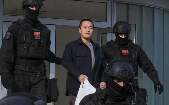 FILE - Montenegrin police officers escort South Korean citizen, Terraform Labs founder Do Kwon in Montenegro's capital Podgorica, Saturday, March 23, 2024.  (AP Photo/Risto Bozovic, File)