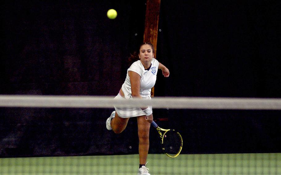 Charlize Caro hits the ball over the net.