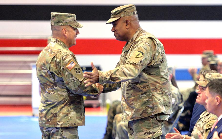 Gen. Darryl Williams, left, commander of U.S. Army Europe and Africa, shakes hands with Brig. Gen. Roger Giraud, the new commander of Medical Readiness Command, Europe. Giraud took the unit's reins from Brig. Gen. Clinton Murray at the Oct. 26, 2023 ceremony in Sembach, Germany.