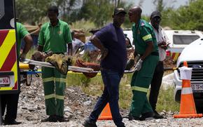 A miner is transported on a stretcher by rescue workers after he was rescued from below ground in an abandoned gold mine in Stilfontein, South Africa, Tuesday, Jan. 14, 2025. (AP Photo/Themba Hadebe)