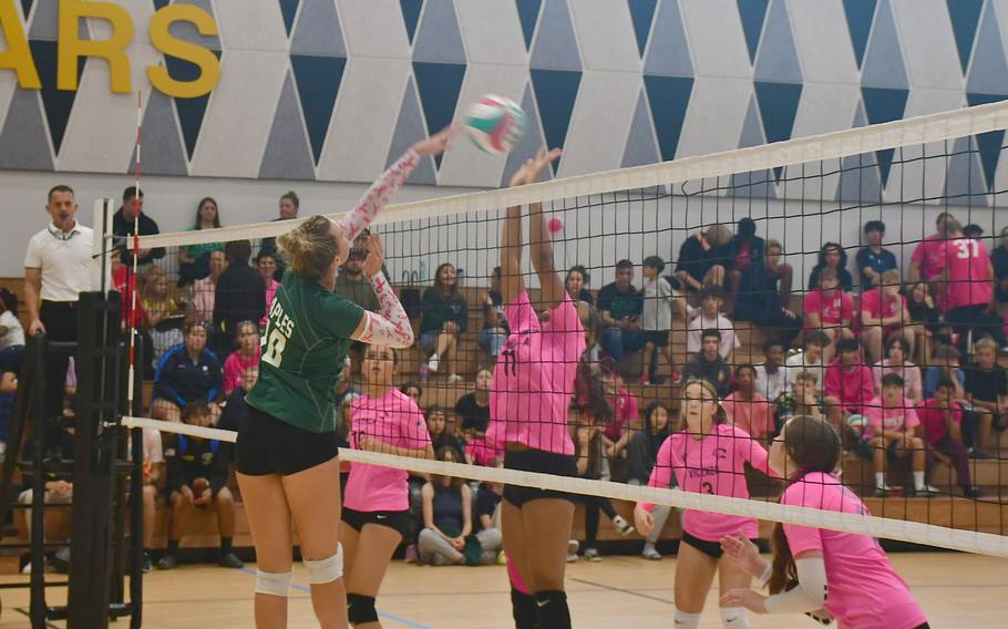 Naples' Gracie Grannis spikes the ball over a Vicenza defender during the second set as the Vicenza Cougars play the Naples Wildcats at Vicenza High School on Oct. 13, 2023.