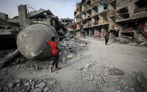 Palestinians inspect the ruins of a mosque destroyed in an Israeli airstrike in Rafah in southern Gaza in February. MUST CREDIT: Loay Ayyoub for The Washington Post